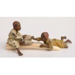 Austrian cold painted bronze model of two children on an elephant tusk reading a book,
