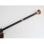 A late 19thC/20thC parasol with 18ct gold plated handle and collar on ebonised stick,