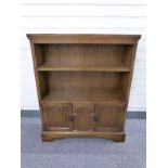 Old Charm or similar oak bookcase with cupboards below W84 x D25 x H103cm