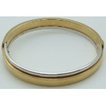 A 9ct bi-coloured gold bangle, 13.