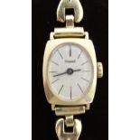 Exquisit 14ct gold ladies wristwatch with black hands and baton markers and silver face,