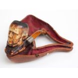 Cased Meerschaum pipe with carved figural decoration, length 15.