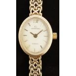 Garrard 9ct gold ladies wristwatch with gold hands and baton markers, champagne face and ETA 976.
