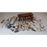 A collection of costume jewellery including beads, brooches, lucite brooch, cameo brooch,