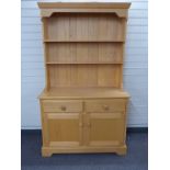 Modern beech or similar dresser with plate rack to top and two drawers and two cupboards to base,