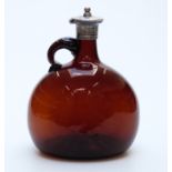 Mallet-shaped brown glass decanter with white metal mount,