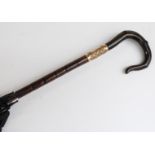 A late 19thC/20thC parasol with horn handle in the form of a crook,