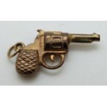 A 9ct gold charm in the form of a revolver,