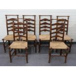 Six ladder back rush seated country dining chairs with turned top rail