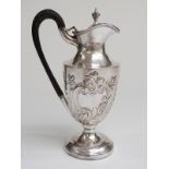 Victorian hallmarked silver pedestal hot water jug with embossed decoration,