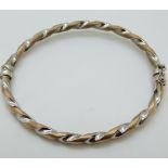 A 9ct bi-coloured gold bangle, 5.