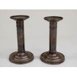 Pair of white metal candlesticks marked sterling, height 14cm,