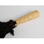 A 19thC/20thC parasol with faux ivory handle,