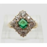 A late Victorian/ early Edwardian ring set with a square step cut emerald of approximately 0.