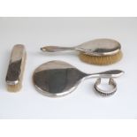 Mappin & Webb three piece hallmarked silver dressing table set and an Egyptian white metal bangle,