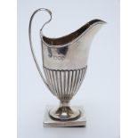 Victorian hallmarked silver helmet shaped cream jug with reeded lower section,