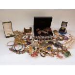 A collection of costume jewellery including two white metal bangles, Victorian mourning brooch,