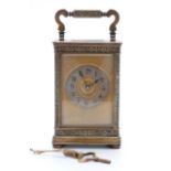 Late 19th / early 20thC brass carriage clock with floral and foliate design to case,