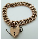 A 9ct rose gold curb link bracelet with a heart padlock clasp, 19.