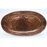 An oval Arts and Crafts style tray with embossed decoration W56cm