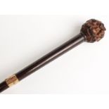 Late 19thC/20thC parasol the wooden handle with all around carving of inverted alternate dogs'