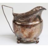 George III hallmarked silver helmet shaped cream jug raised on ball feet,