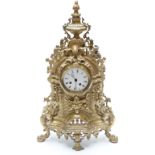 French 19thC ornate gilt brass mantel clock featuring a green man mask and urn finial,