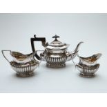 Victorian hallmarked silver three piece bachelor's tea set with reeded lower section,