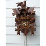 Three train Black Forest German cuckoo clock with musical movement