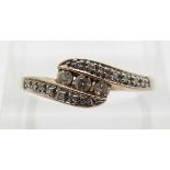 A 9ct gold ring set with diamonds in a twist setting,