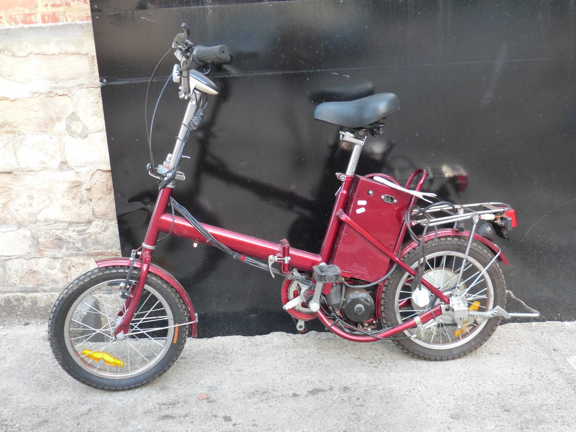 An electric folding bicycle in red