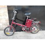 An electric folding bicycle in red