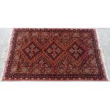 Afghan style rug with all over geometric decoration on burn orange ground,