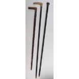 Three walking canes including hallmarked silver mounted, carved,
