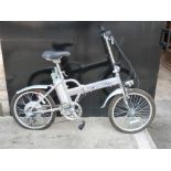 An electric folding bicycle in silver