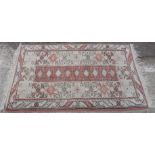 Three similar rugs all with geometric decoration of burnt orange ground,