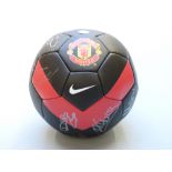 Manchester United football signed by 20 of the team together with facsimile signed 2009-10 card.