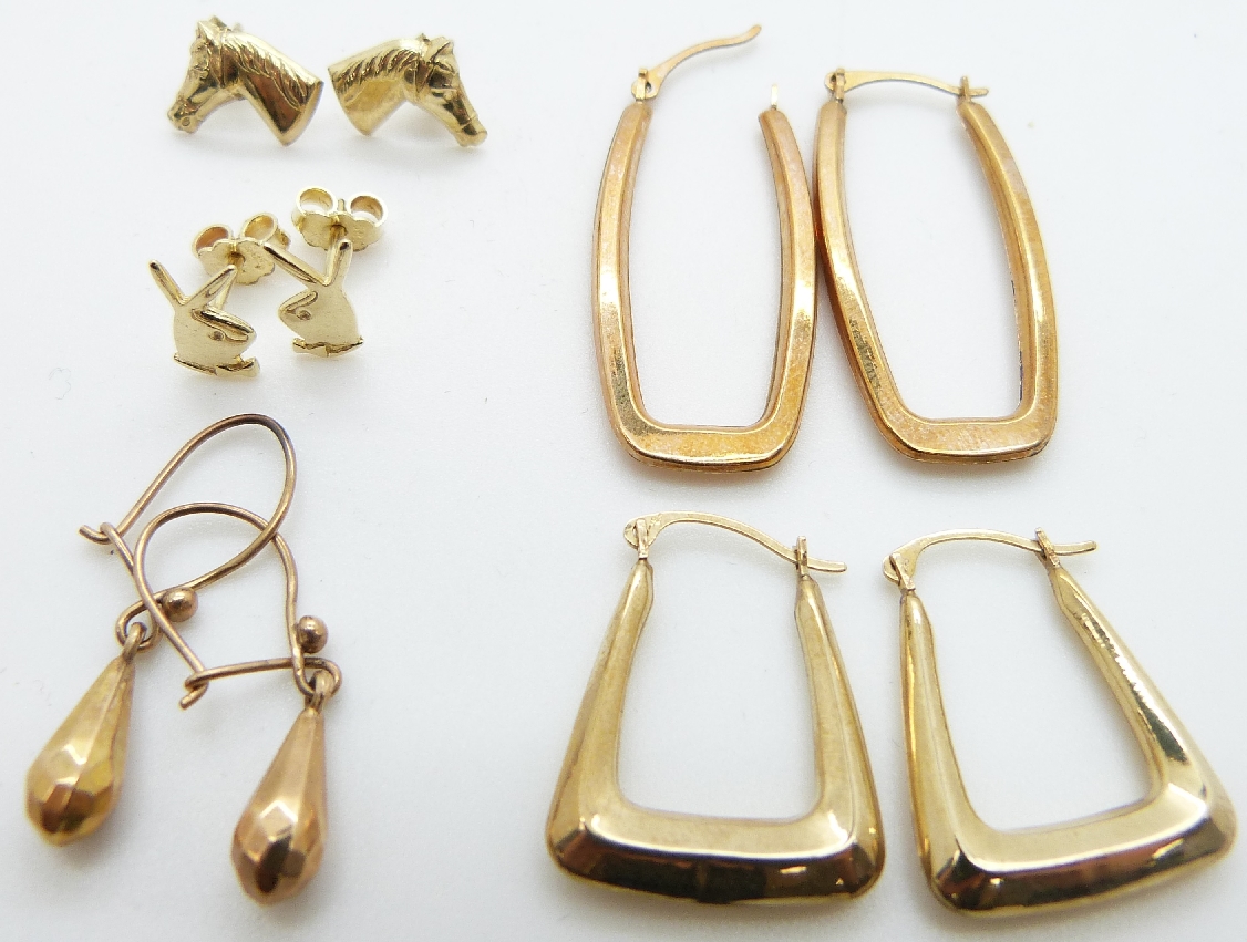 Three 9ct gold earrings (2.7g), a pair of 14ct gold earrings (1g) and a pair of yellow metal