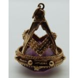 A 9ct gold Masonic fob set with purple paste