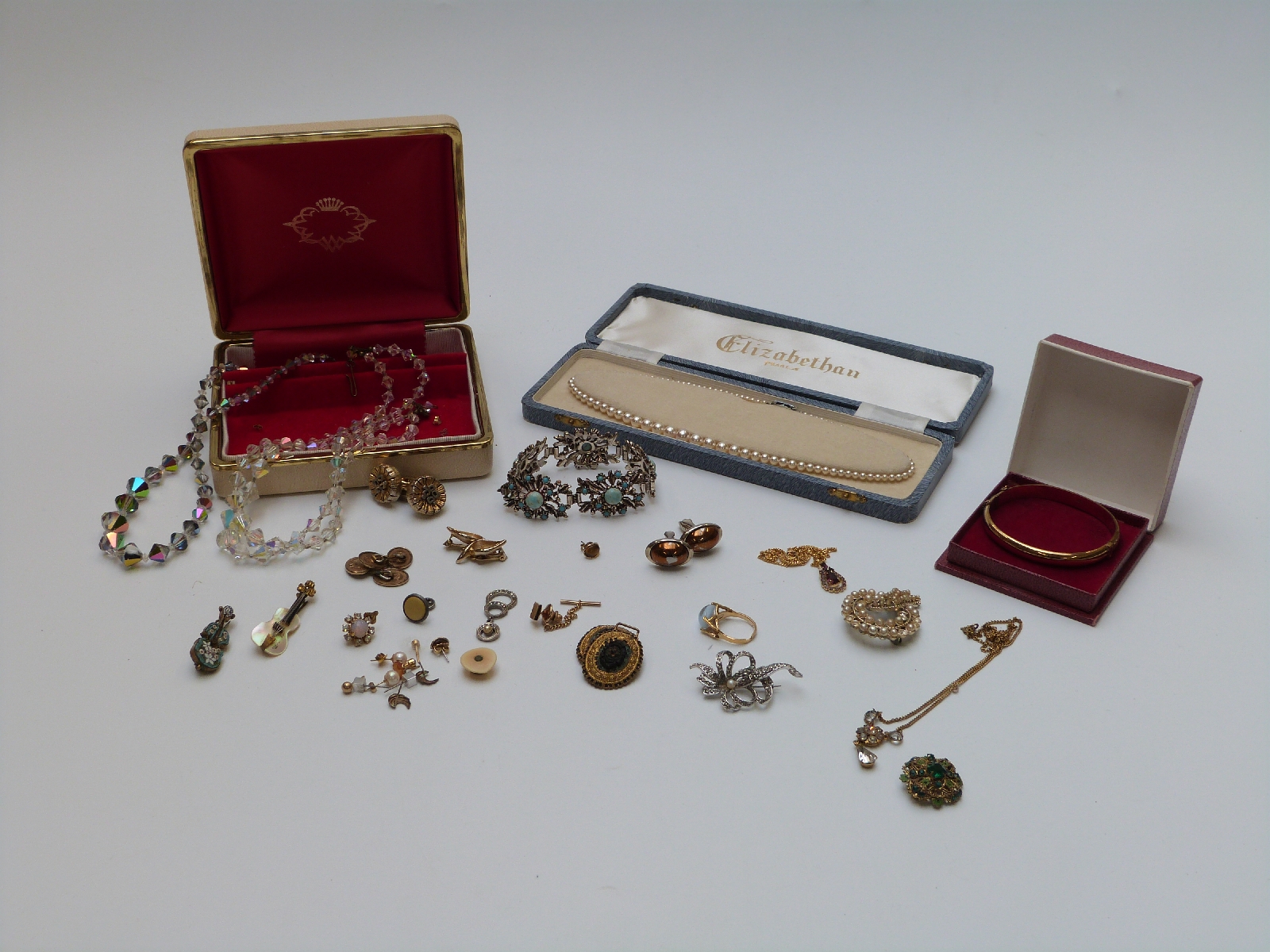 A collection of costume jewellery including rolled gold bangle, earrings, brooches etc