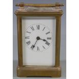Early to mid twentieth century brass carriage clock in corniche style case, the white enamel Roman