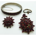 A suite of Victorian Bohemian garnet jewellery comprising brooch, pendant, bangle and ring