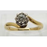 An 18ct gold ring set with a diamond of approximately 0.2ct in a platinum setting, size J