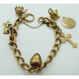 An 18ct gold charm bracelet with a 9ct gold cross, anchor charm, other charms etc, 21.7g