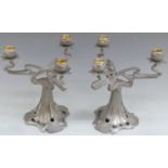 A pair of Art Nouveau pewter three branch candelabra in the style of Archibald Knox, height 26cm