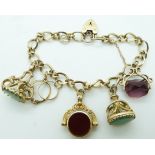 A 9ct gold charm bracelet with two 9ct gold fobs, two 9ct gold swivel fob charms and a ring charm,