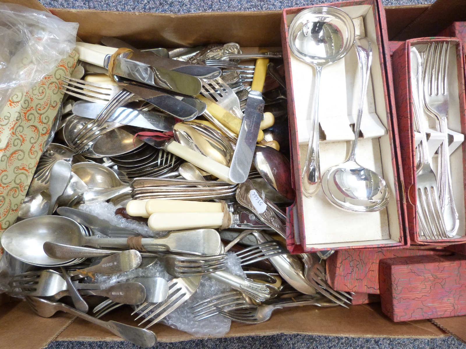 A large quantity of boxed and loose silver plated and other cutlery, many matching