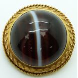 Victorian gold brooch set with a banded agate cabochon in a foiled mount verso a glass compartment