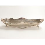 Mexican white metal long dish raised on cast bar stand, marks rubbed but sterling Mexico visible,
