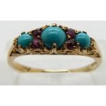 An 19ct gold ring set with turquoise and rubies.